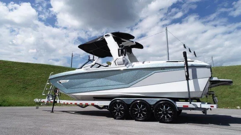 Slide: The Image of 2020 Nautique Paragon P25 boat on trailer under blue sky. - 9