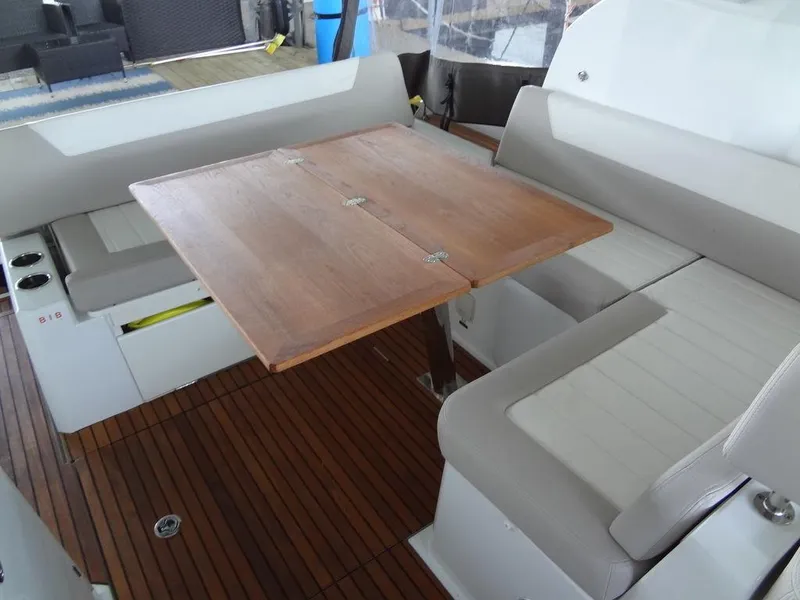 Slide: The Image of Jeanneau LEADER 36 2017 boat interior seating with white and beige upholstery. - 23