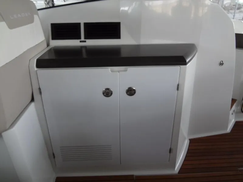 Slide: The Image of 2017 Jeanneau LEADER 36 interior with white seating and wooden flooring. - 24