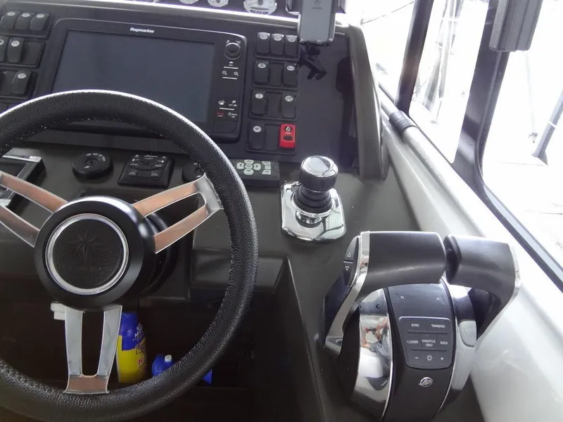 Slide: The Image of 2017 Jeanneau LEADER 36 yacht docked in a marina under a covered structure. - 36