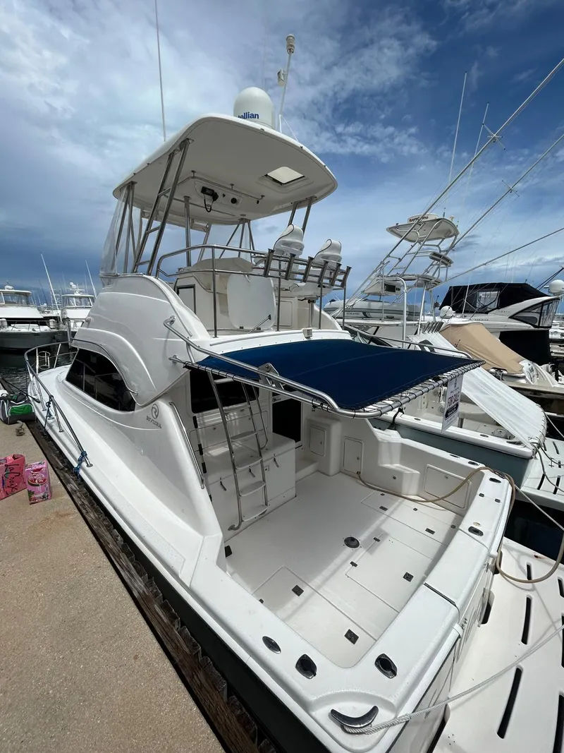 The Image of 2005 Riviera 37 Flybridge yacht with spacious deck and flybridge, docked at marina. - 1