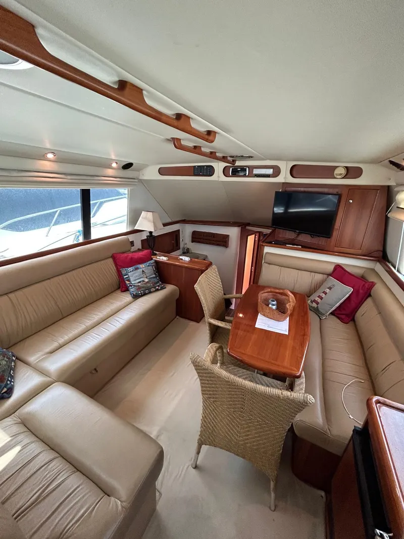 Slide: The Image of Luxurious interior of 2005 Riviera 37 Flybridge yacht with elegant seating and dining area. - 7