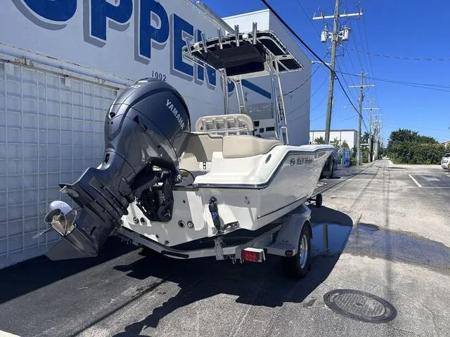 Slide: The Image of 2024 Key West 203 FS boat with Yamaha engine on trailer, parked outdoors. - 17