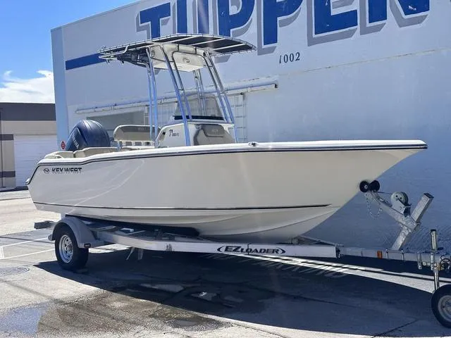 Slide: The Image of 2024 Key West 203 FS boat on trailer, parked outdoors. - 2