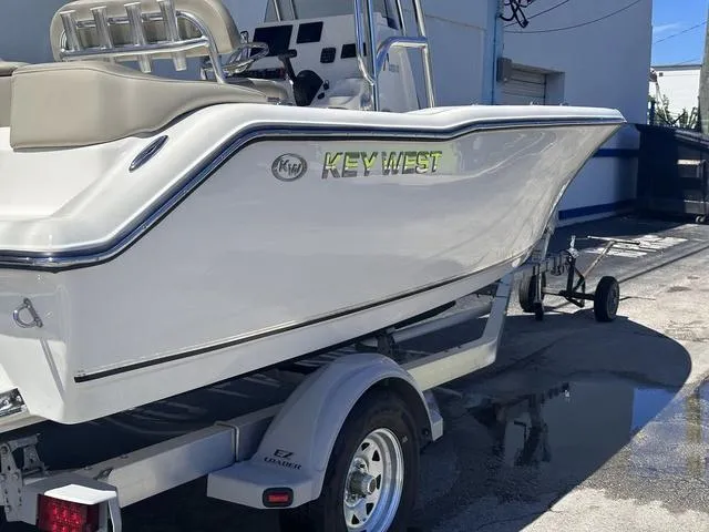 Slide: The Image of 2024 Key West 203 FS boat on trailer, side view in a sunny outdoor setting. - 3