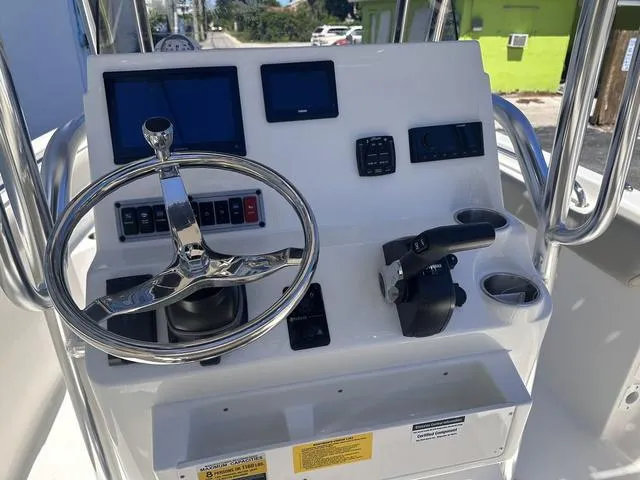 Slide: The Image of 2024 Key West 203 FS boat dashboard with steering wheel and controls. - 6