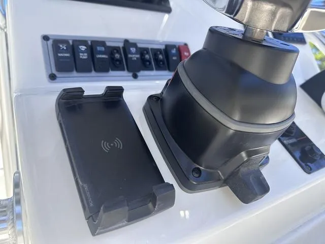 Slide: The Image of 2024 Key West 203 FS boat dashboard with controls and wireless charging pad. - 7