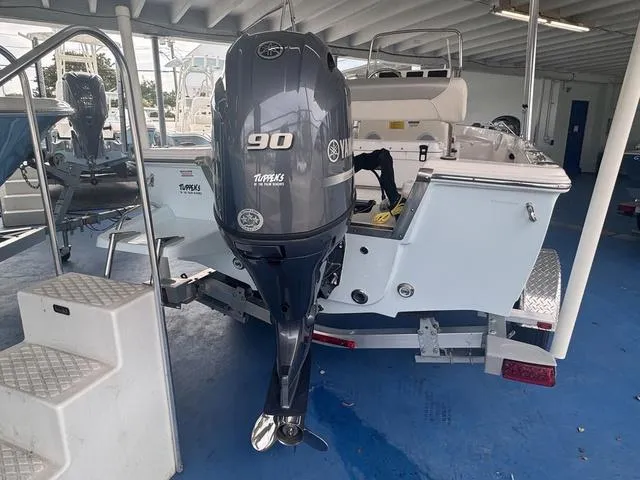 Slide: The Image of 2024 Key West 1720 CC boat interior with console and seating under clear sky. - 5