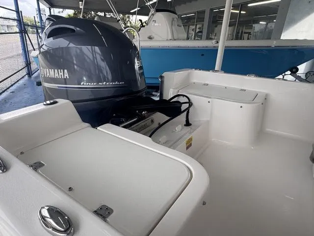 Slide: The Image of 2024 Key West 1720 CC boat console with steering wheel and navigation controls. - 6