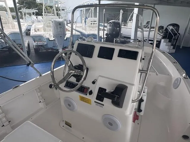 Slide: The Image of 2024 Key West 1720 CC boat with open storage compartment and outboard motor. - 8