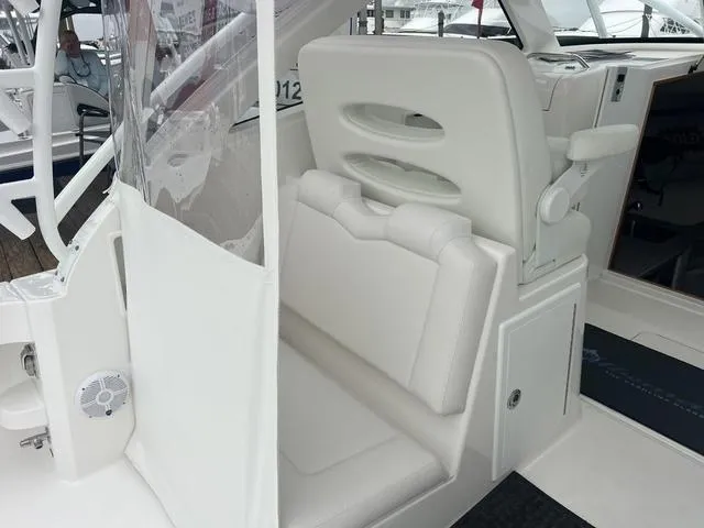 Slide: The Image of 2025 Albemarle 30 Express boat interior with white seating and helm station. - 16