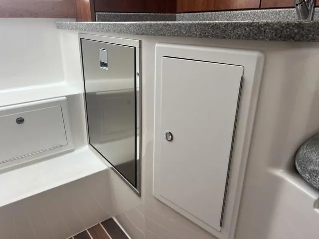 Slide: The Image of 2025 Albemarle 30 Express boat interior with storage compartments and countertop. - 21