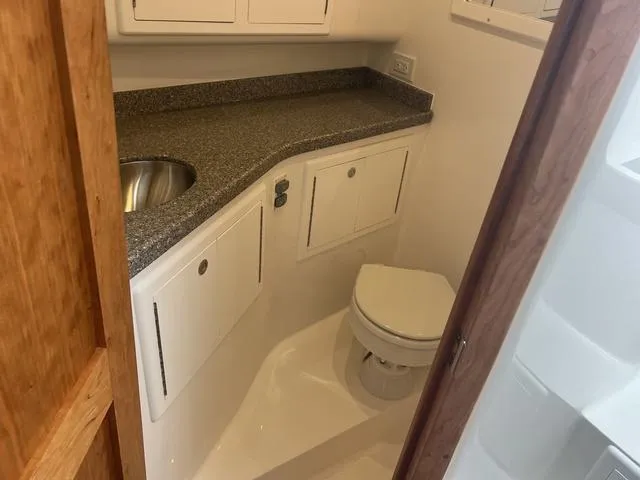 Slide: The Image of 2025 Albemarle 30 Express boat bathroom with sink and toilet. - 22
