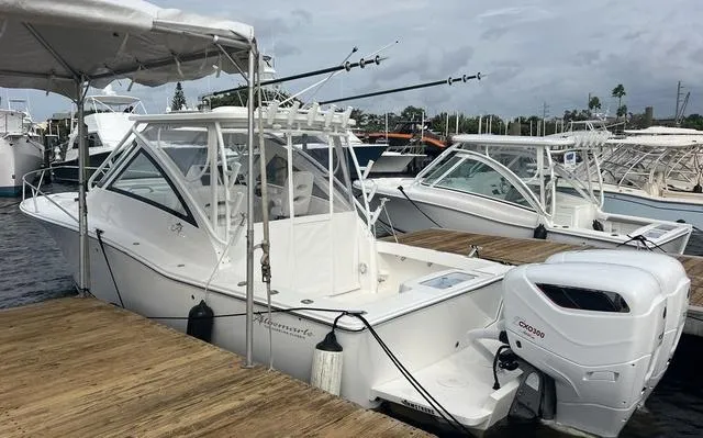 Slide: The Image of 2025 Albemarle 30 Express boat docked with outboard engine. - 23