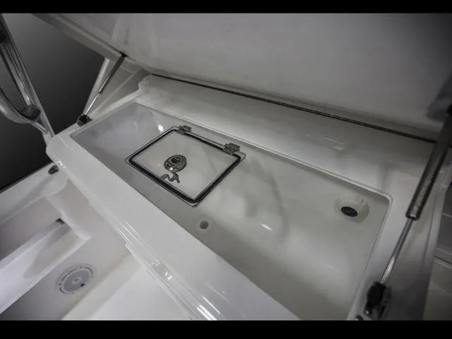 Slide: The Image of 2024 Albemarle 41 Express boat storage compartment with stainless steel latch. - 11