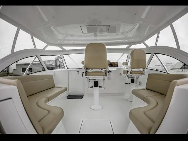 Slide: The Image of Interior of 2024 Albemarle 41 Express boat with beige seating and modern helm. - 12