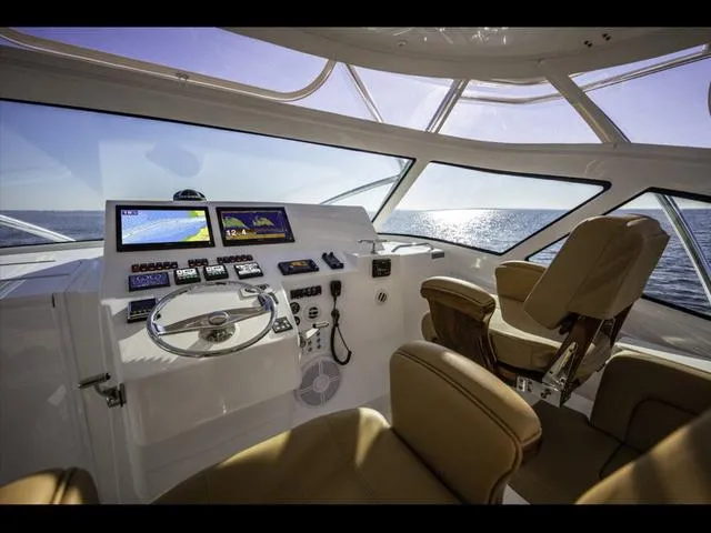 Slide: The Image of Interior of 2024 Albemarle 41 Express yacht with modern navigation controls and leather seating. - 15