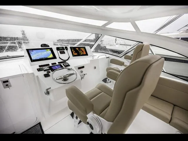 Slide: The Image of 2024 Albemarle 41 Express helm with modern navigation displays and comfortable seating. - 18