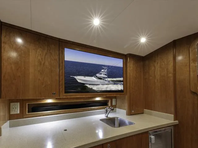 Slide: The Image of Luxurious interior of 2024 Albemarle 41 Express yacht with wood cabinetry and modern amenities. - 21