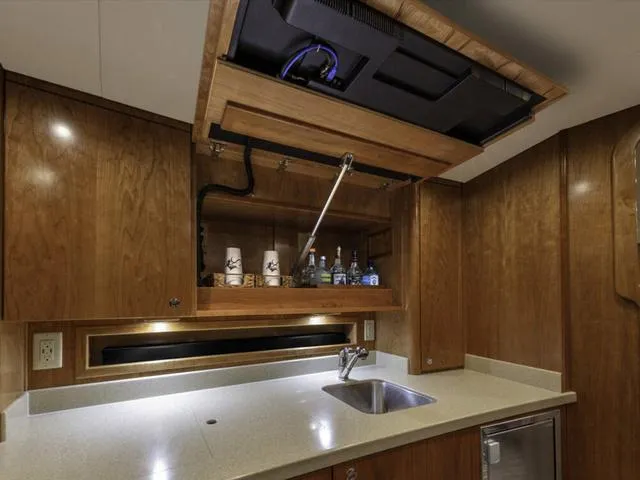 Slide: The Image of Luxurious 2024 Albemarle 41 Express yacht interior with modern kitchenette and wooden cabinetry. - 22
