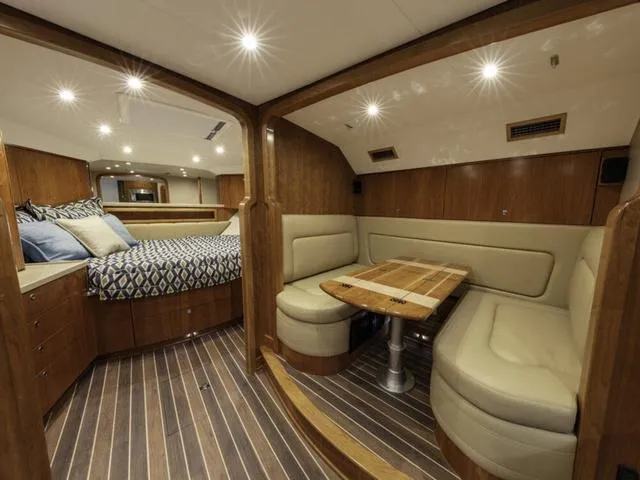 Slide: The Image of Luxurious interior of 2024 Albemarle 41 Express yacht with cozy seating and elegant wood finishes. - 23