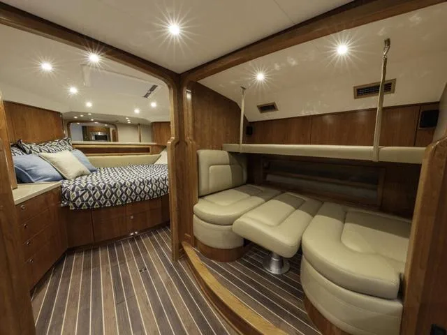 Slide: The Image of Luxurious interior of 2024 Albemarle 41 Express yacht with elegant wood finish and cozy seating. - 24