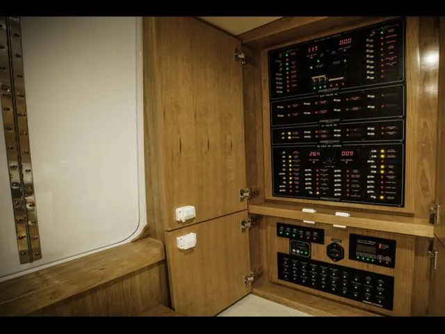 Slide: The Image of 2024 Albemarle 41 Express electrical panel with wooden cabinetry. - 28