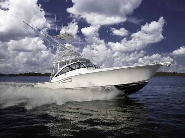 Slide: The Image of 2024 Albemarle 41 Express boat cruising on open water under cloudy sky. - 33