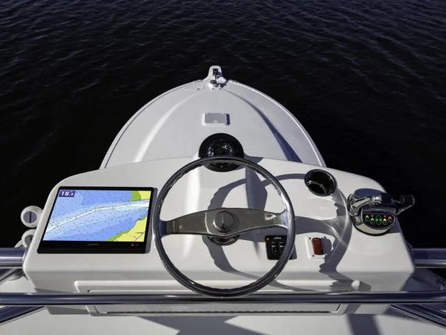 Slide: The Image of 2024 Albemarle 41 Express helm with navigation display and steering wheel. - 8