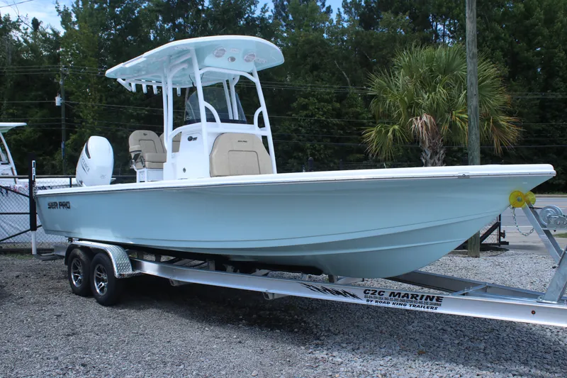Slide: The Image of 2025 Sea Pro 250 Bay boat on trailer, parked outdoors. - 1