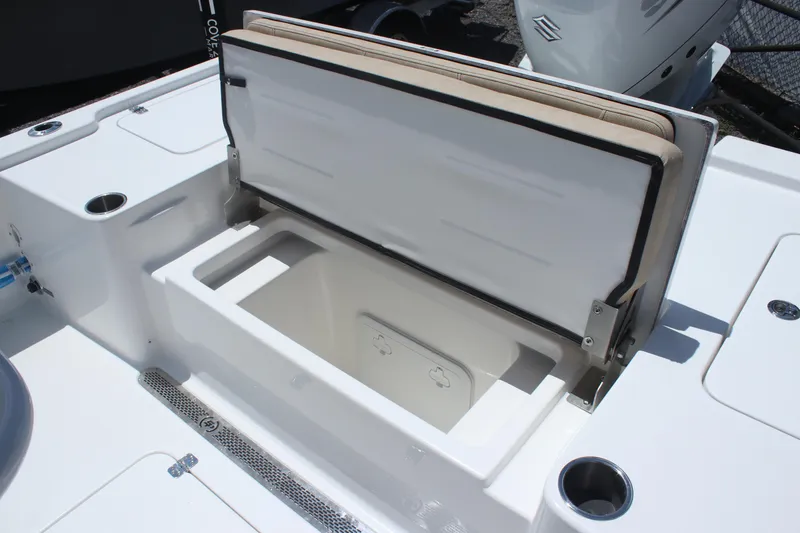 Slide: The Image of 2025 Sea Pro 250 Bay boat storage compartment with open lid, showcasing interior space. - 10