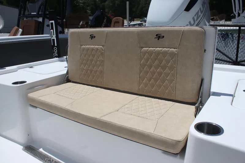 Slide: The Image of 2025 Sea Pro 250 Bay boat with beige cushioned seating and cup holders. - 11