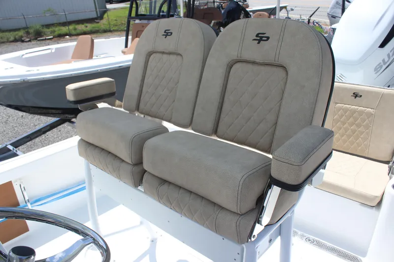 Slide: The Image of 2025 Sea Pro 250 Bay boat with dual cushioned seats and steering wheel. - 12