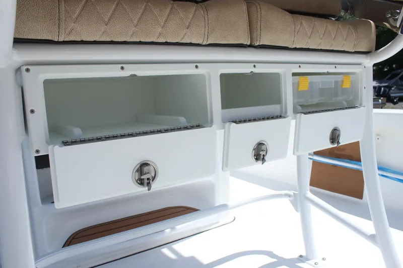 Slide: The Image of 2025 Sea Pro 250 Bay boat storage compartments with cushioned seating. - 14