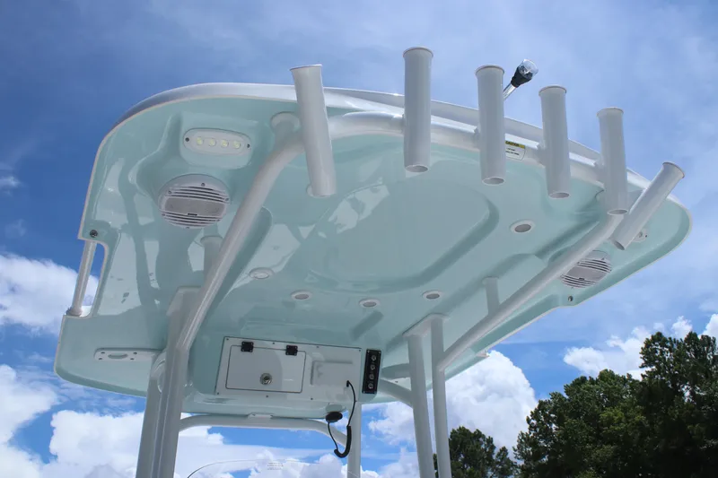 Slide: The Image of T-top of 2025 Sea Pro 250 Bay boat with rod holders against blue sky. - 18