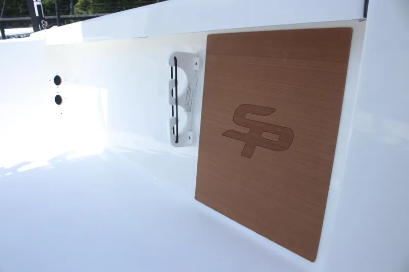 Slide: The Image of 2025 Sea Pro 250 Bay boat detail with logo on wooden panel. - 19