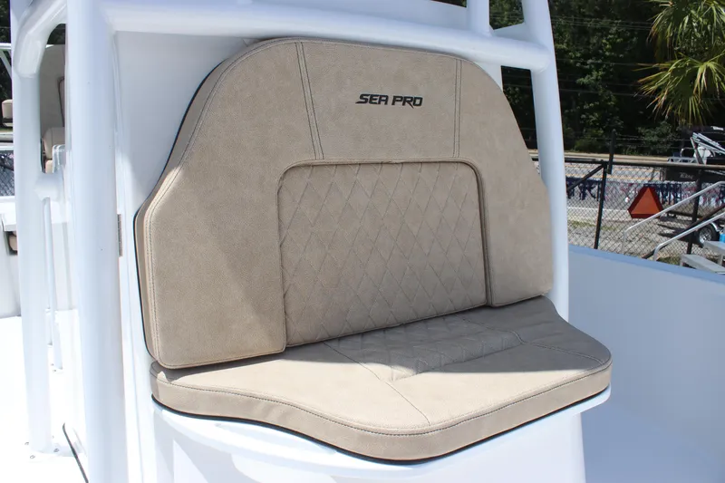 Slide: The Image of 2025 Sea Pro 250 Bay boat seat with beige upholstery and logo. - 20