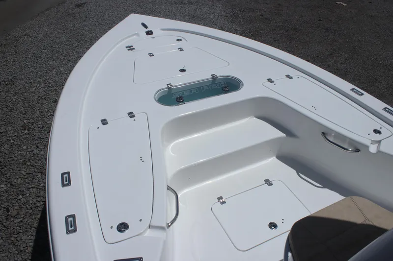 Slide: The Image of 2025 Sea Pro 250 Bay boat deck with storage compartments and seating. - 21