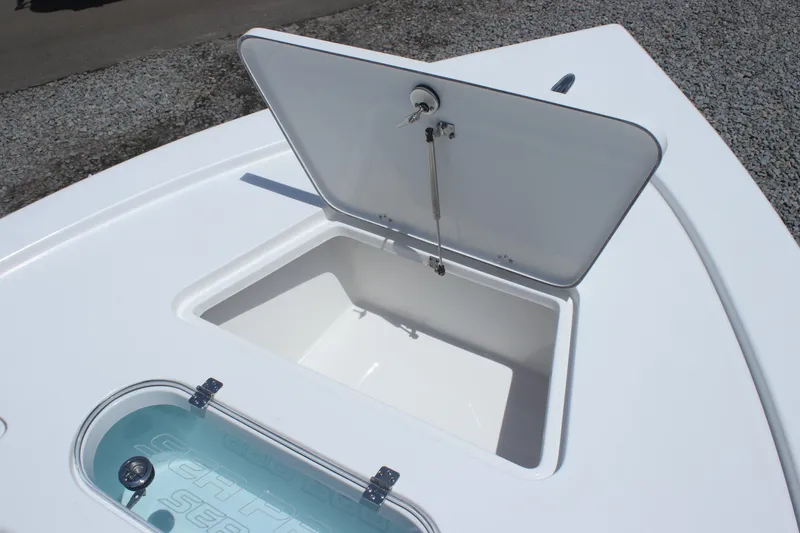 Slide: The Image of 2025 Sea Pro 250 Bay boat storage compartment with open hatch, showcasing interior space. - 23