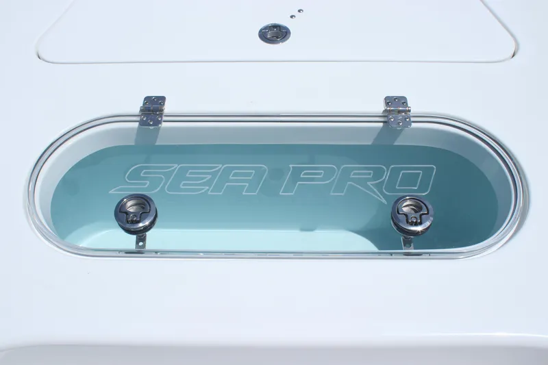 Slide: The Image of 2025 Sea Pro 250 Bay boat livewell with logo and dual latches. - 24