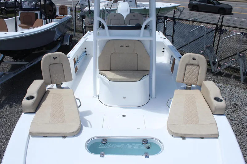 Slide: The Image of 2025 Sea Pro 250 Bay boat interior with beige seating and center console. - 28