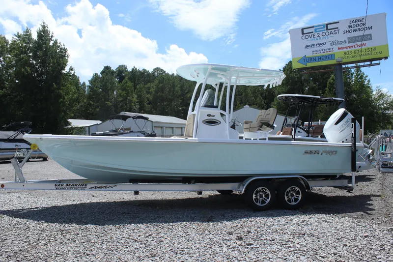 Slide: The Image of 2025 Sea Pro 250 Bay boat on trailer, displayed outdoors under a clear sky. - 3