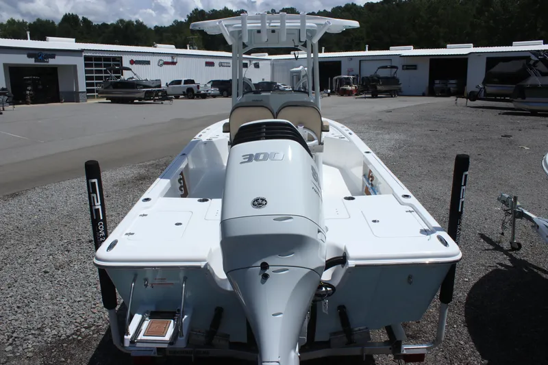 Slide: The Image of 2025 Sea Pro 250 Bay boat with powerful outboard motor in a dealership lot. - 4