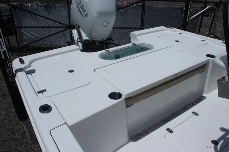 Slide: The Image of 2025 Sea Pro 250 Bay boat deck with storage compartments and motor. - 7