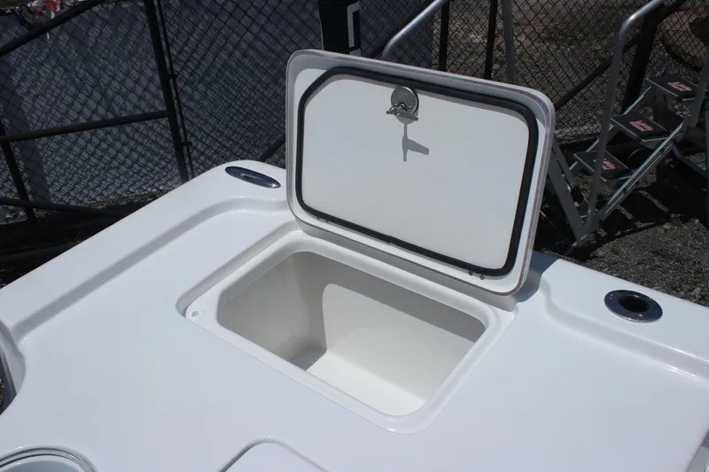 Slide: The Image of 2025 Sea Pro 250 Bay boat storage compartment with open lid, showcasing interior space. - 8