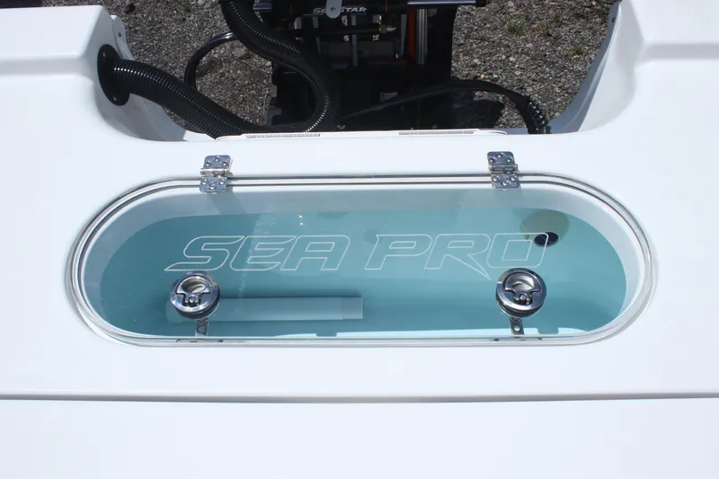 Slide: The Image of 2025 Sea Pro 250 Bay livewell with clear lid and dual latches. - 9