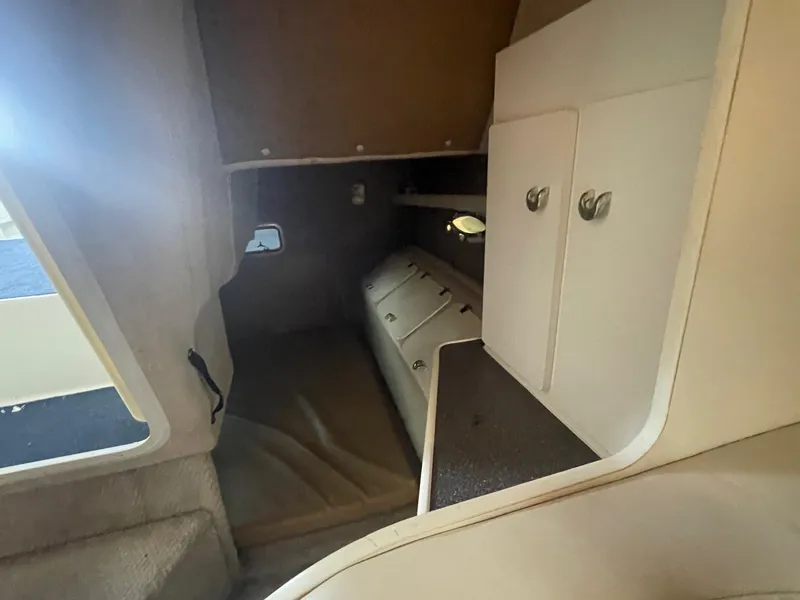 Slide: The Image of Interior cabin of 1998 Rinker Fiesta Vee 280 boat, featuring storage cabinets. - 11