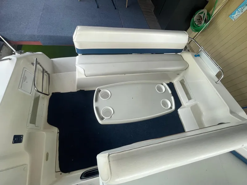Slide: The Image of 1998 Rinker Fiesta Vee 280 boat interior with seating and table. - 5