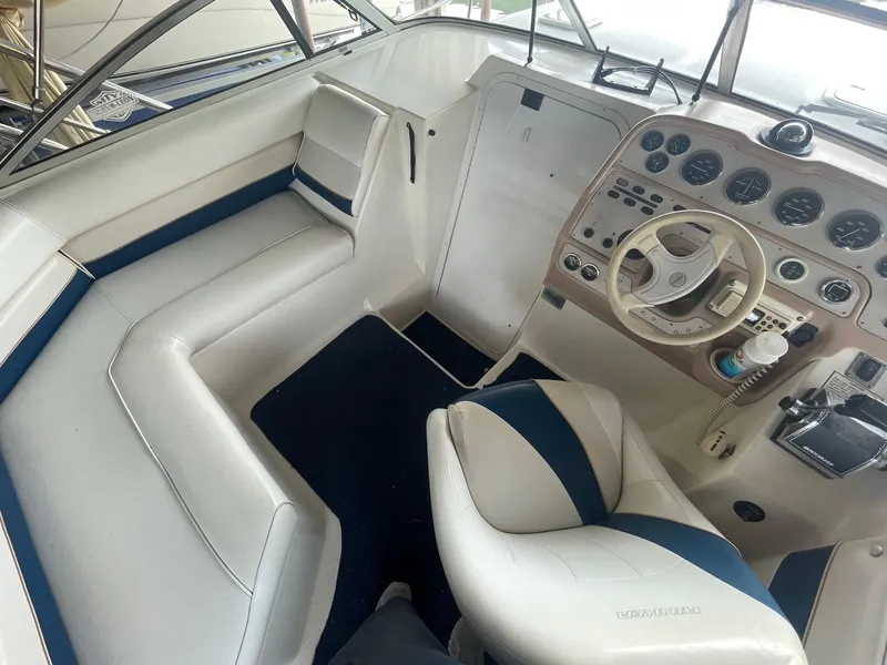 Slide: The Image of Interior of 1998 Rinker Fiesta Vee 280 boat with steering wheel and seating. - 7