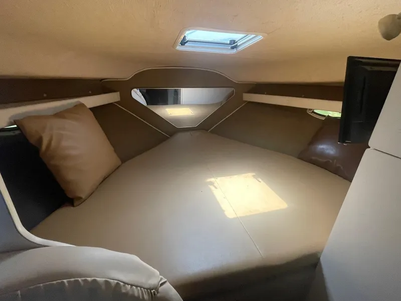 Slide: The Image of 1998 Rinker Fiesta Vee 280 cabin interior with bed and skylight. - 9